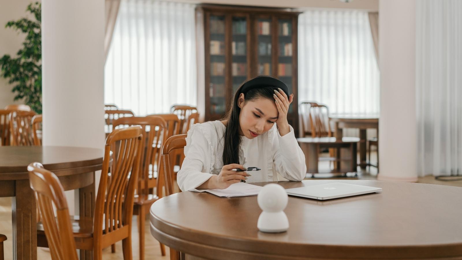 Family Friends Refuse to Leave After Spending Years Paying Below Market Rent in Mom’s House Woman sitting at a table, frustrated by a situation