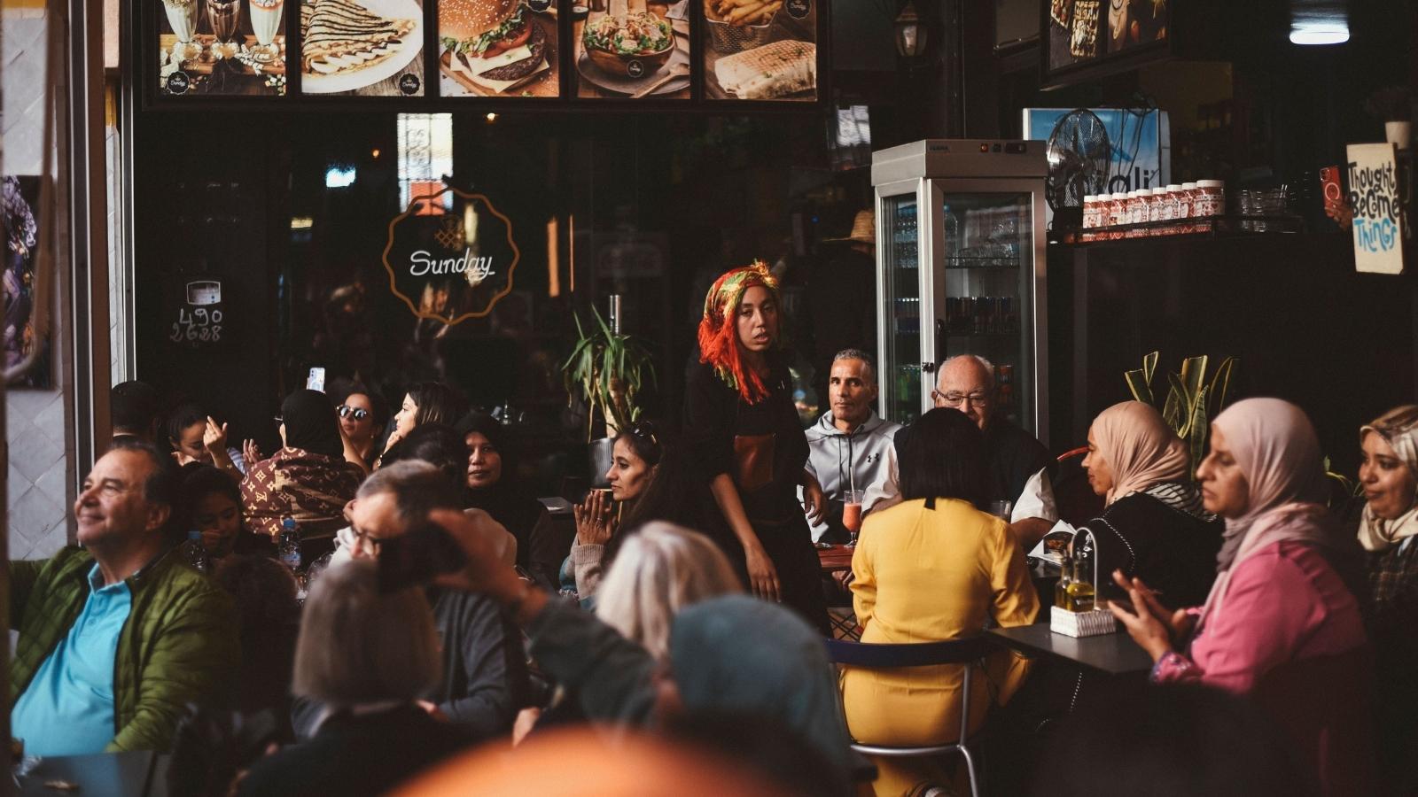 Server Asks Diners to Free Up Table for Waiting Customers, and the Situation Quickly Escalates Busy server looking upset after a long day