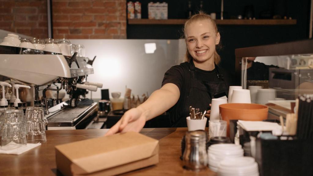 Woman handing a customer their order