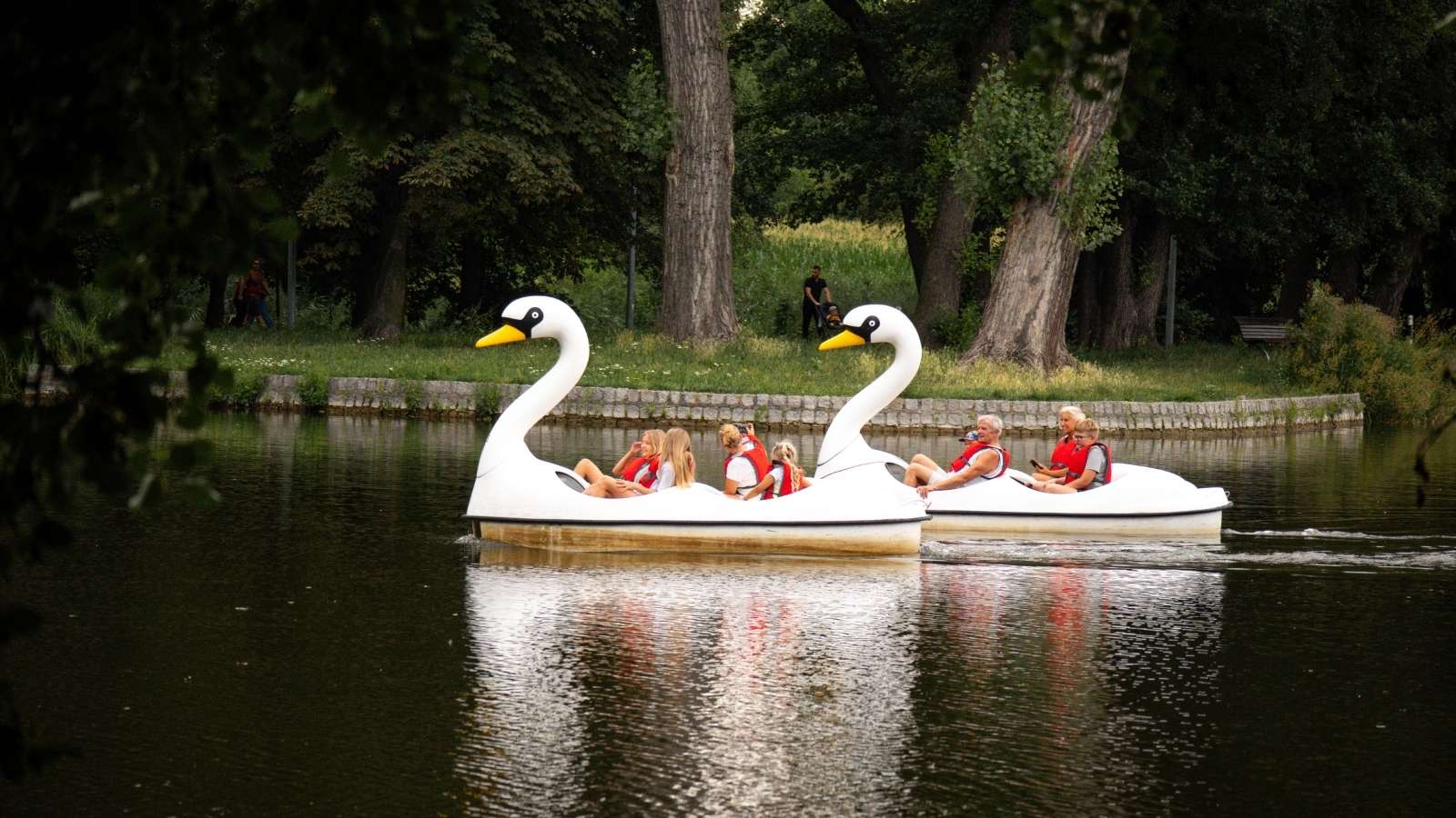 A Park Ranger Wouldnt Let Two Boaters Launch Without an Inspection — So They Found Another Way In, and Got Removed From the Park People driving swan boats on a lake in the park