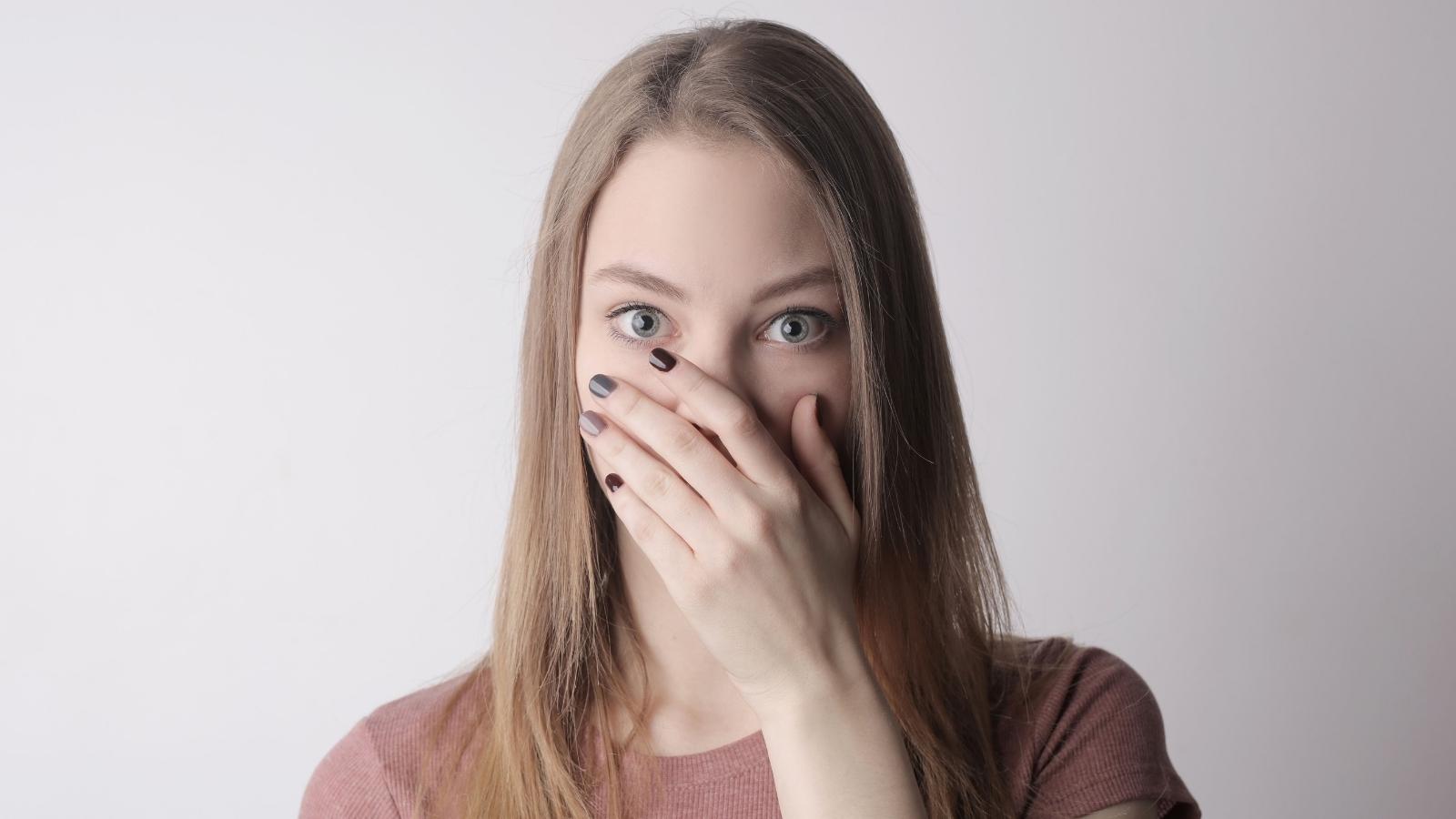 Woman covering her nose to not smell fart
