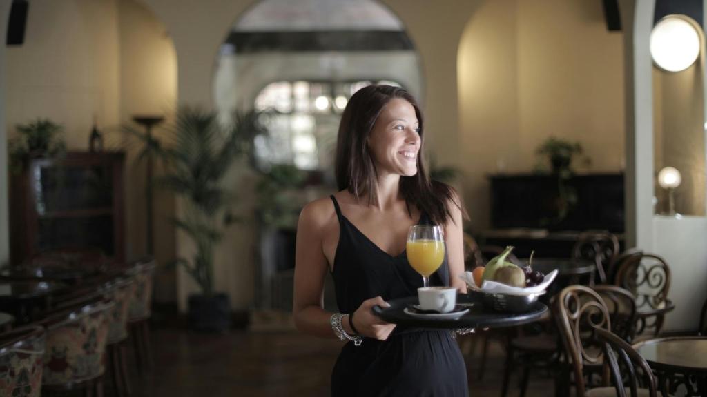 Brunch server walking with someone's drinks