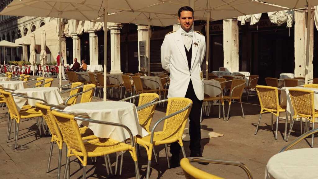 Waiter standing outside on the patio