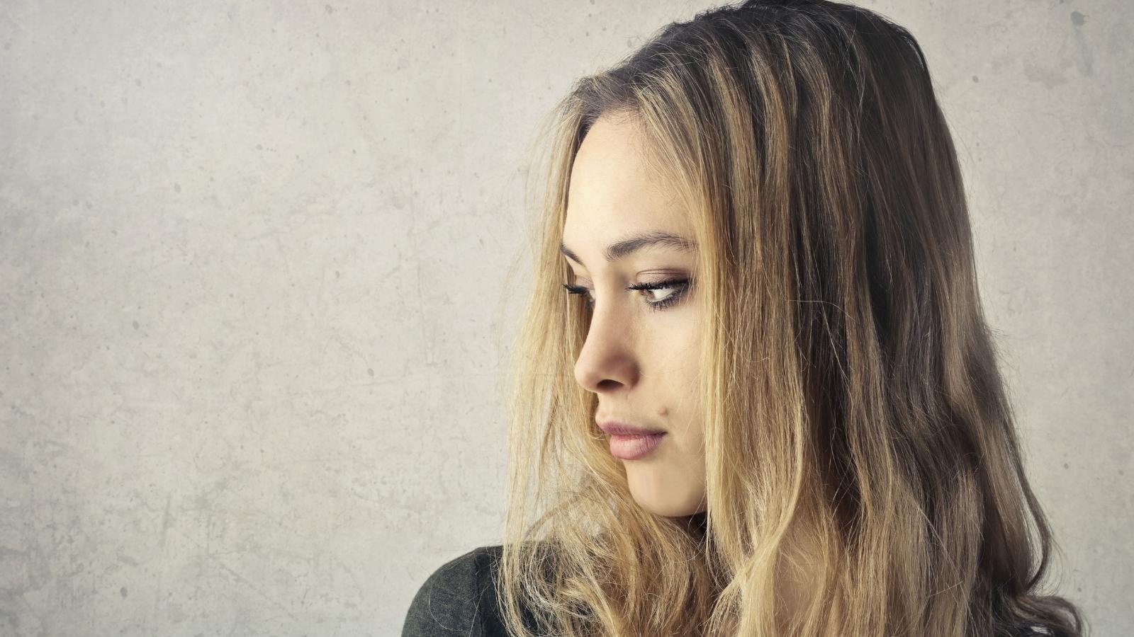 Young Woman Looks for Way to Skip Family Trip, Considers Working Christmas Shift Instead Young woman thinking about a family gathering