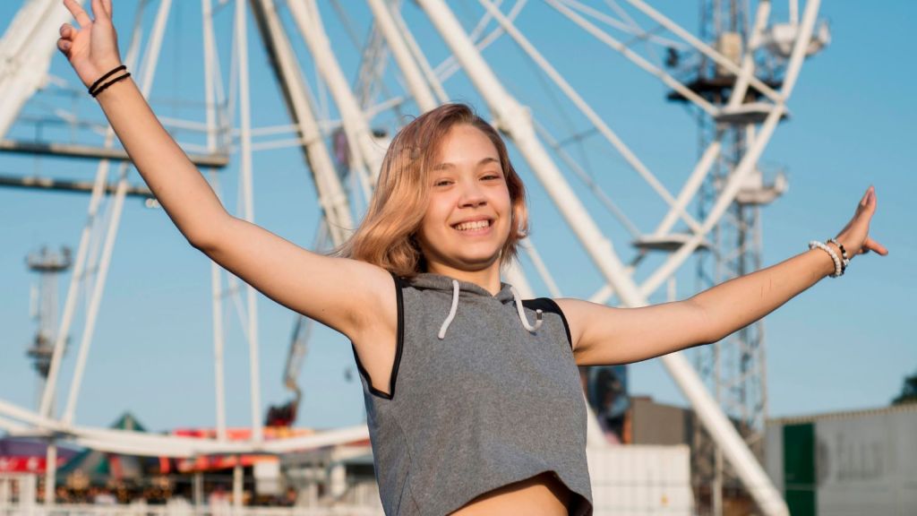 Teenage girl feeling happy at a theme park