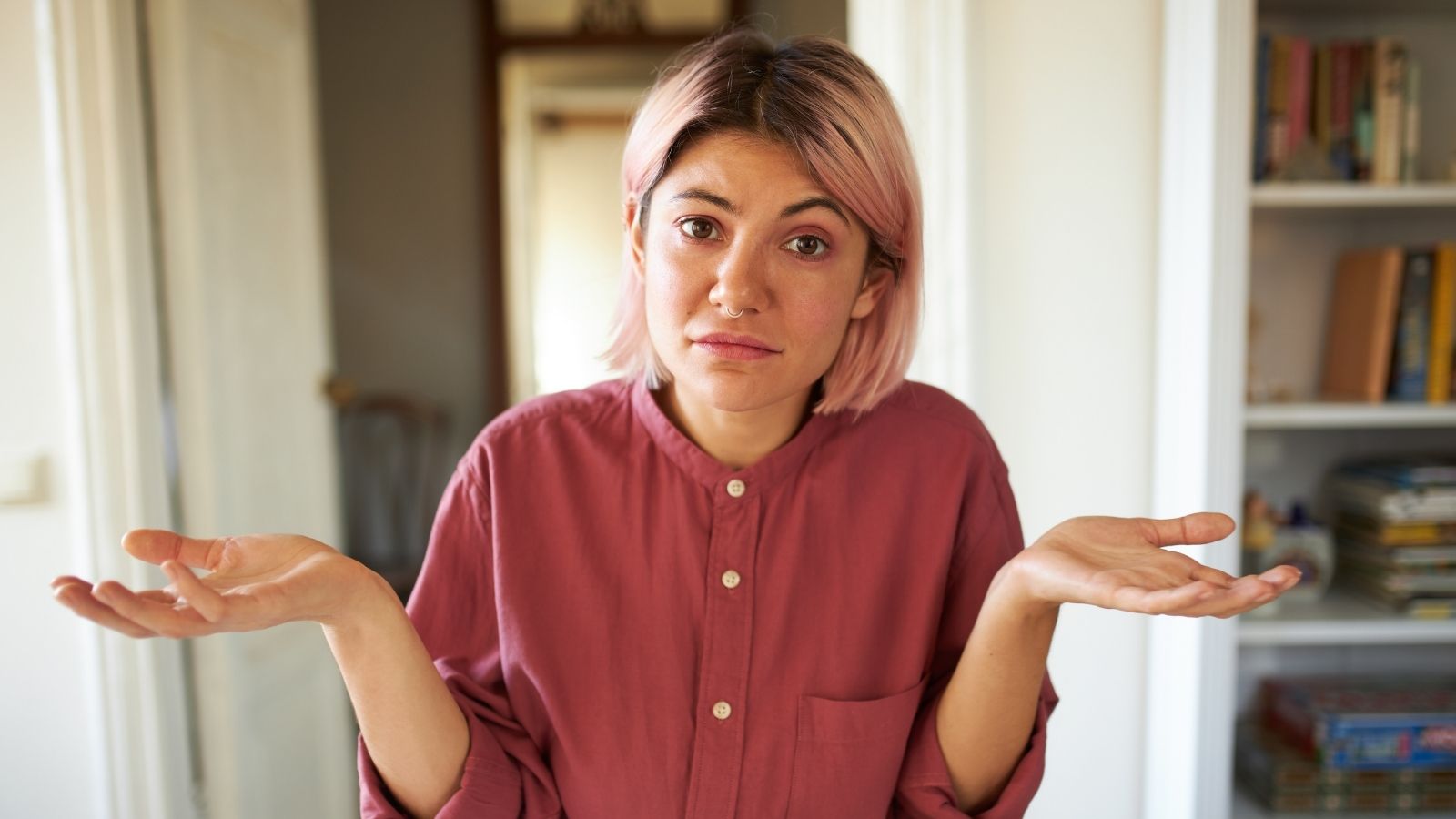 frustrated young woman shrugging
