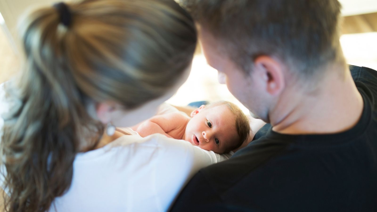 Exhausted New Parents Reach Breaking Point Over Neighbor Kids Disruptive Doorbell Games parents holding newborn baby