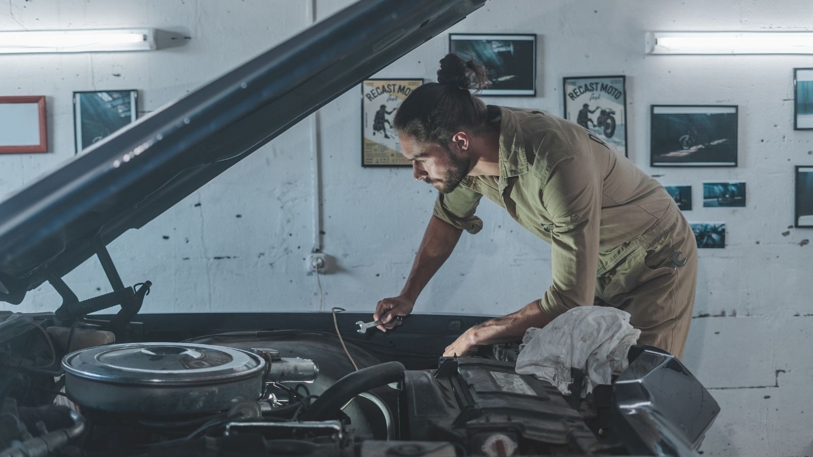 Neighbors Complain About a Car Enthusiast’s Garage in a Residential Area, so He Sells It—Only for It to End Up With the Hell’s Angels man working on a car in his garage
