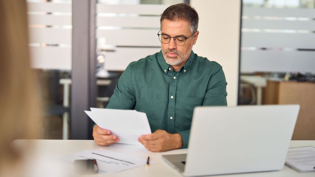middle aged businessman looking at paperwork