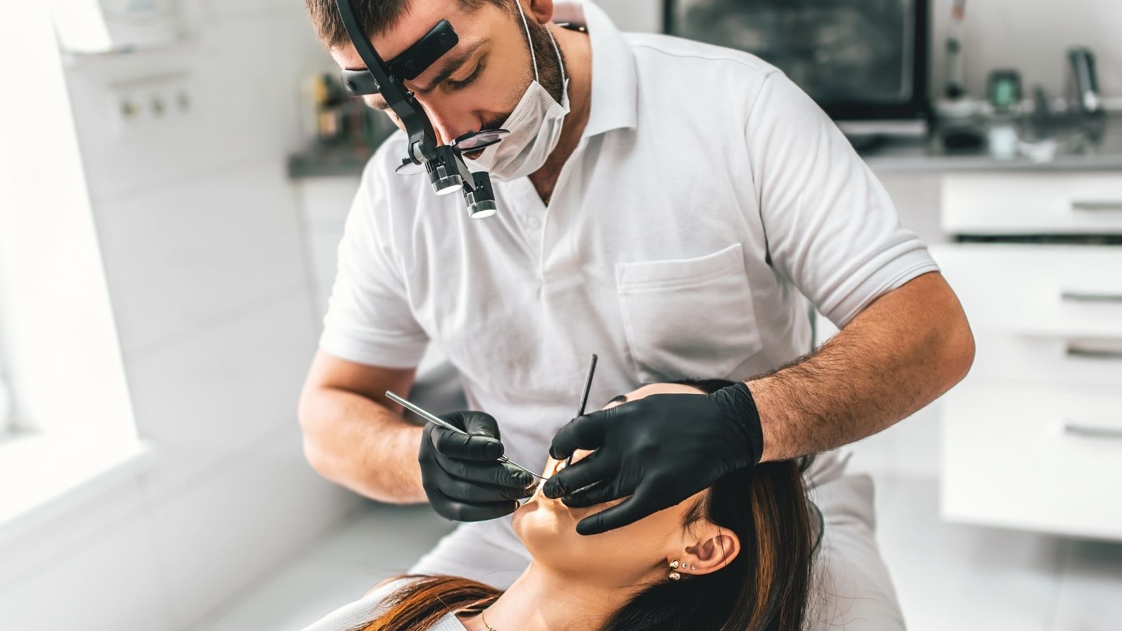 Receptionist Doesn’t Want to Offend Her Coworker at the Dental Office, but Feels She Needs to Speak Up for Herself dentist operating on woman's teeth