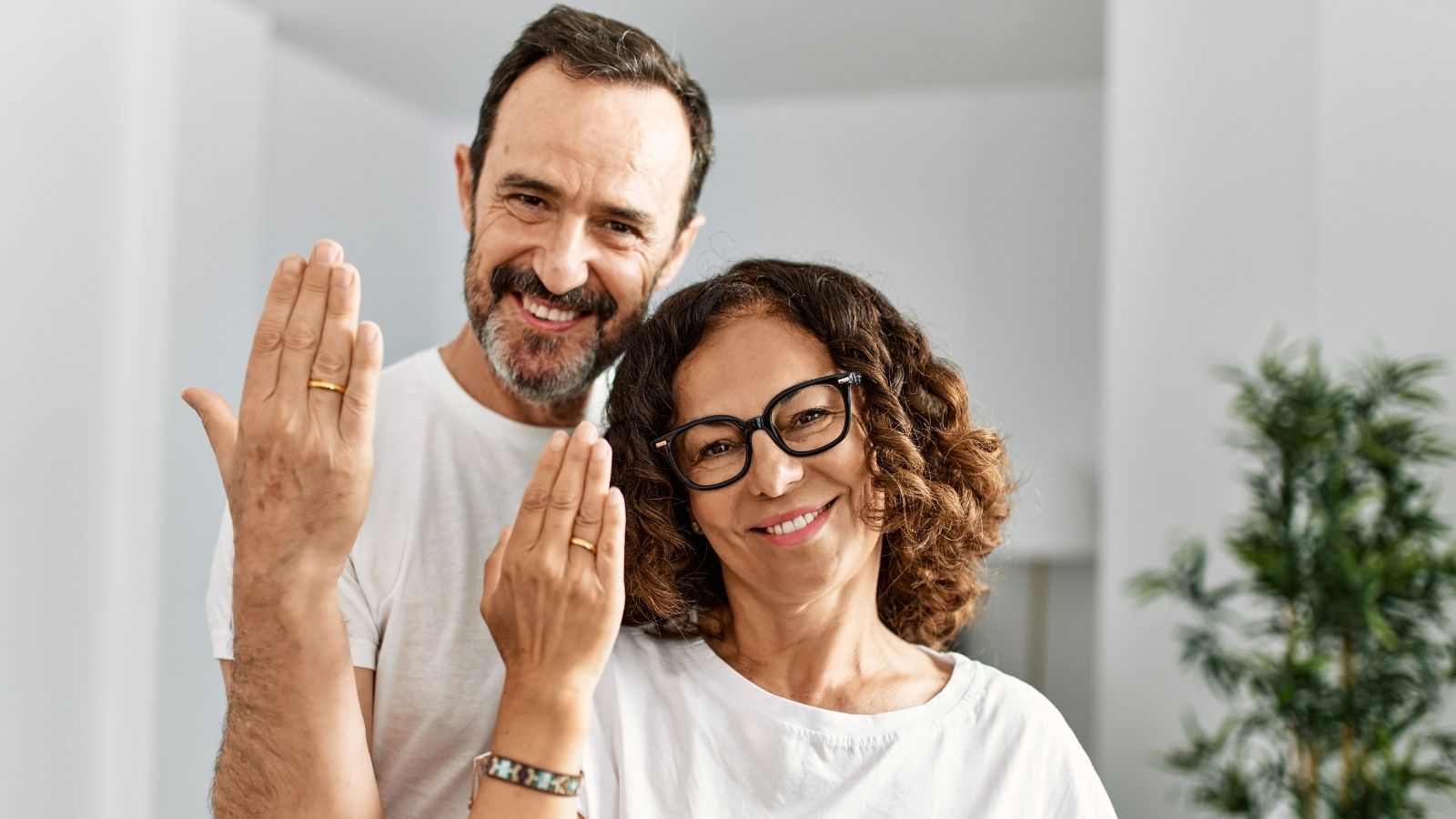 Man Keeps Wedding Secret From Family, but Years After Divorce His Daughter Considers Inviting His Ex Wife Instead middle aged couple holding up their hands to show wedding bands