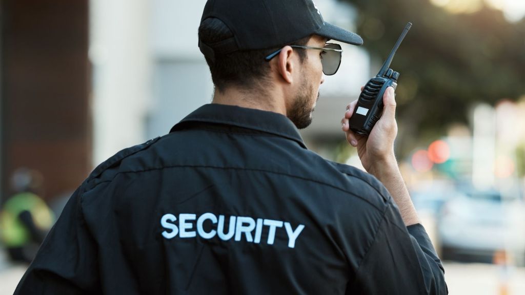 security guard talking into a radio