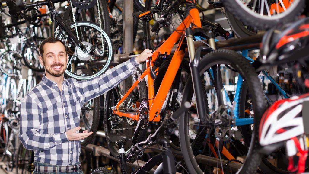 man working in a store that sells bikes