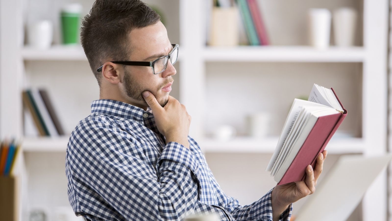 Boss Orders Employee to Stay Late With No Work to Do, so He Spends Overtime Reading a Book man reading a book at work