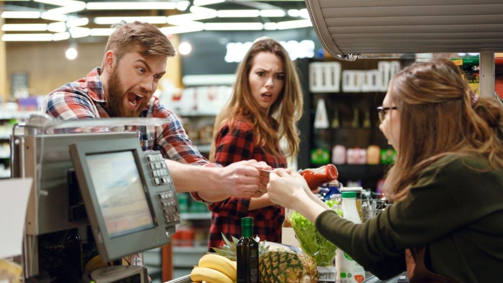 angry man yelling at cashier at grocery store