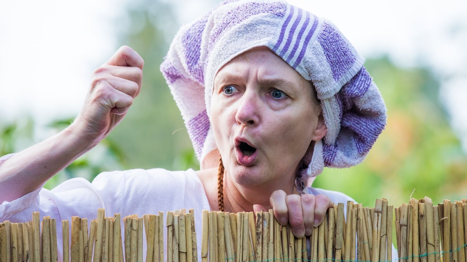 A “No HOA” Neighborhood Still Comes With Unexpected Rules From One Neighbor angry woman with a towel on her head yelling over a fence