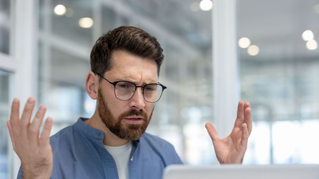 frustrated businessman throwing up his hands
