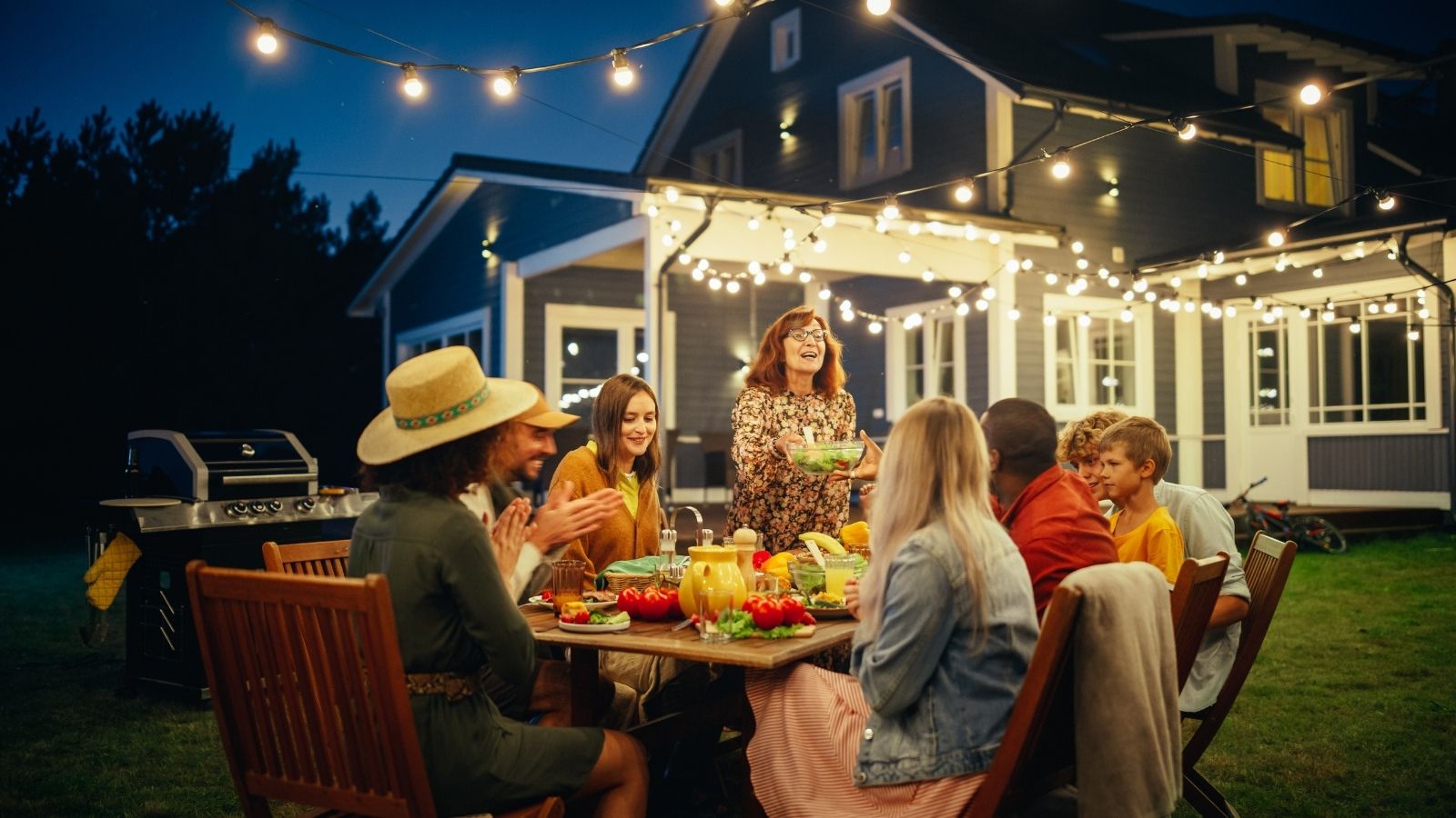 friends at a backyard BBQ at night