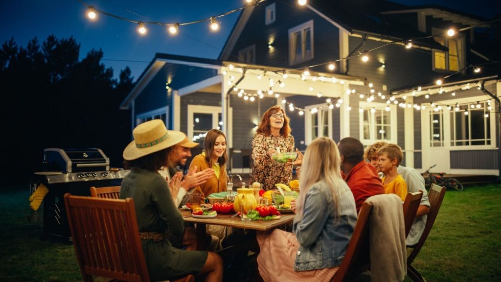friends at a backyard BBQ at night
