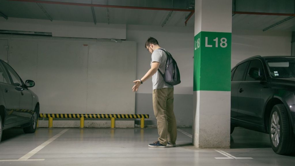 man standing in parking spot