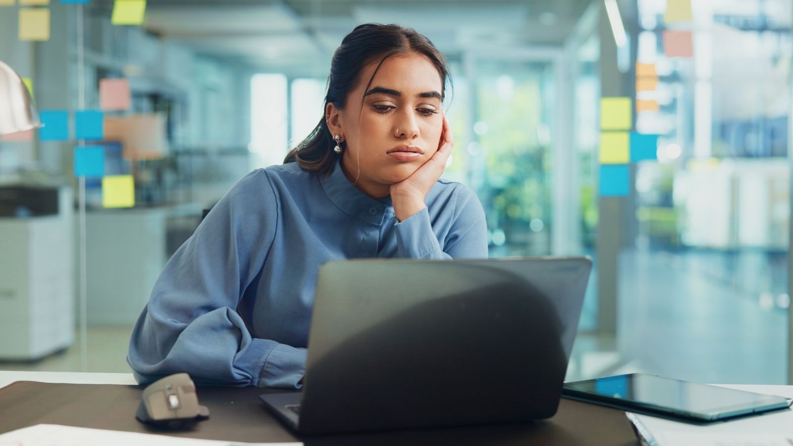 bored businesswoman looking at her laptop
