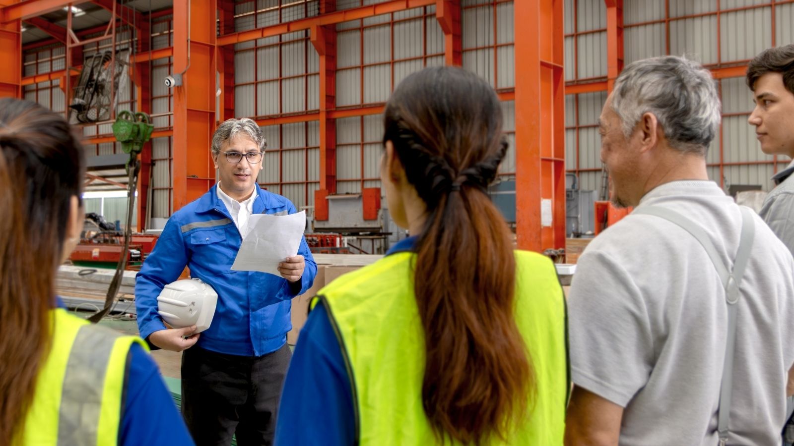 Supervisor Screamed at an Employee for Asking a Question in a Meeting — a Coworker Reported Him to HR supervisor talking to employees in a factory