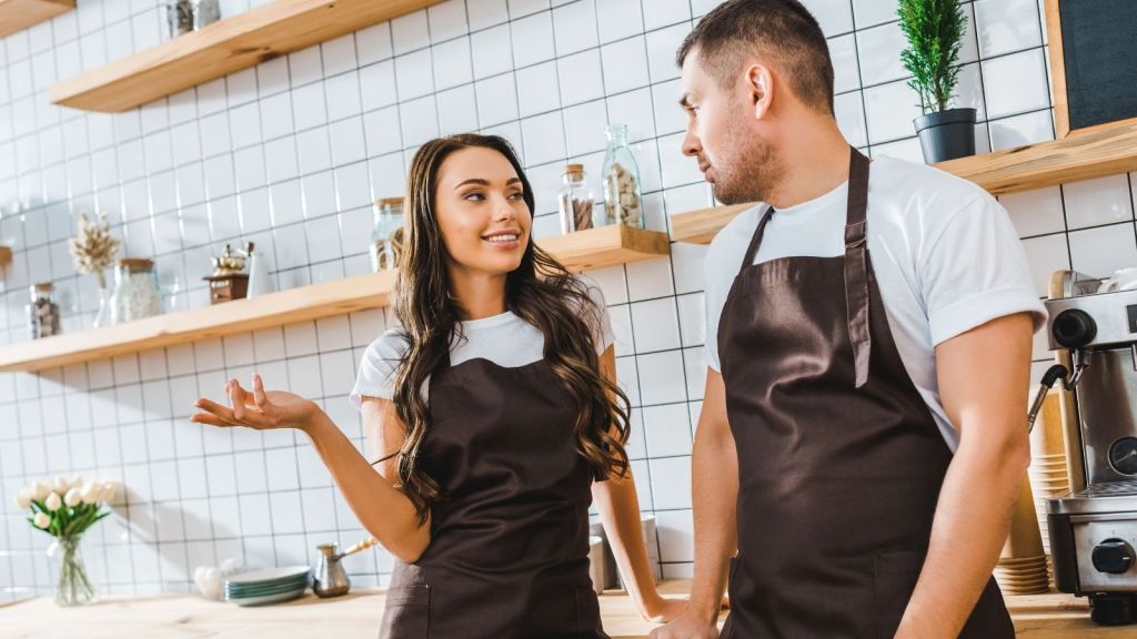 two cashiers talking