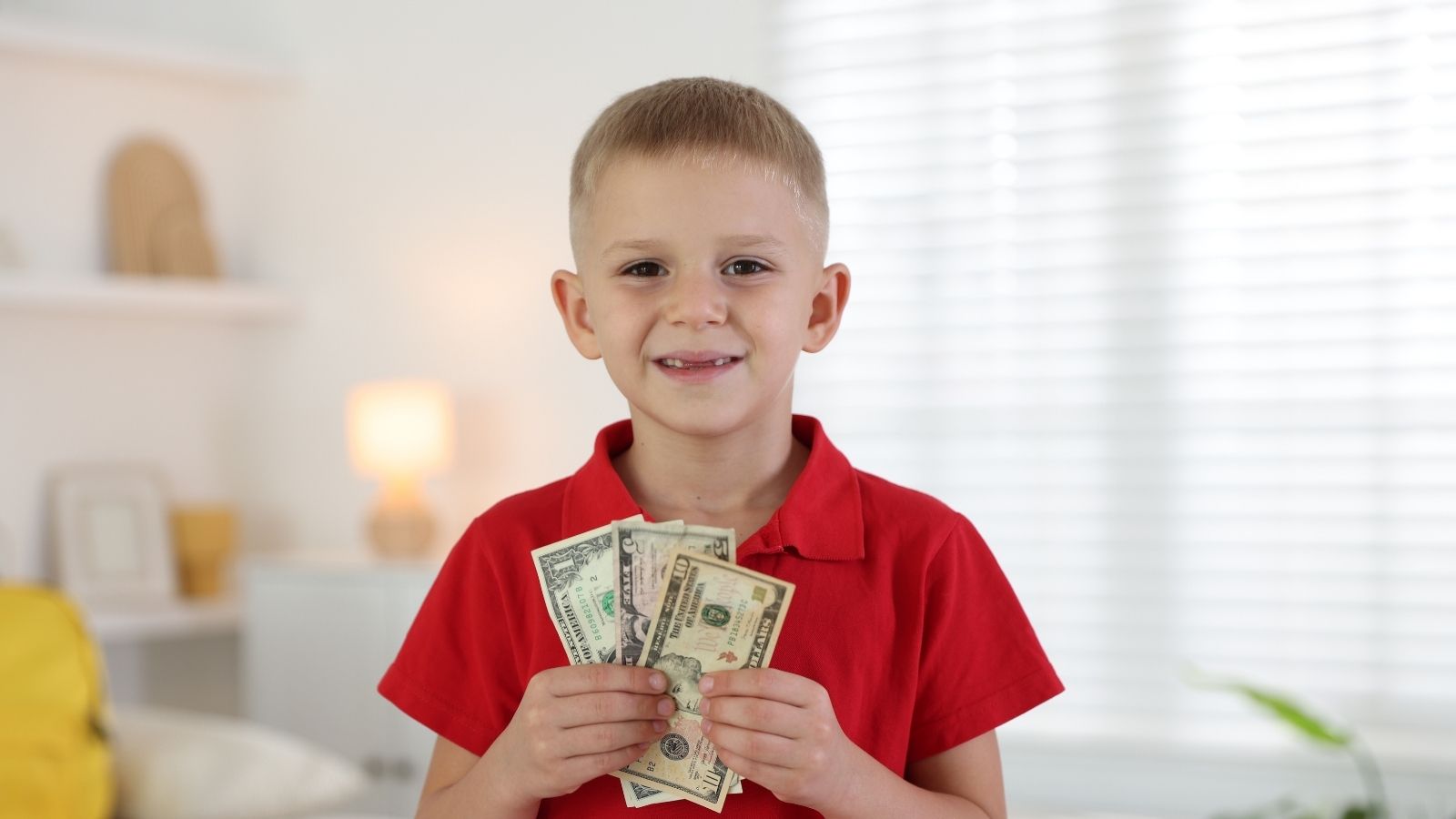 little boy holding money