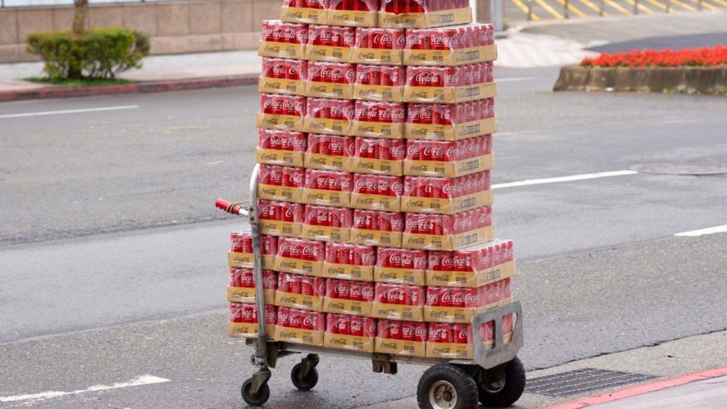 cases of Coca-Cola stacked on a cart