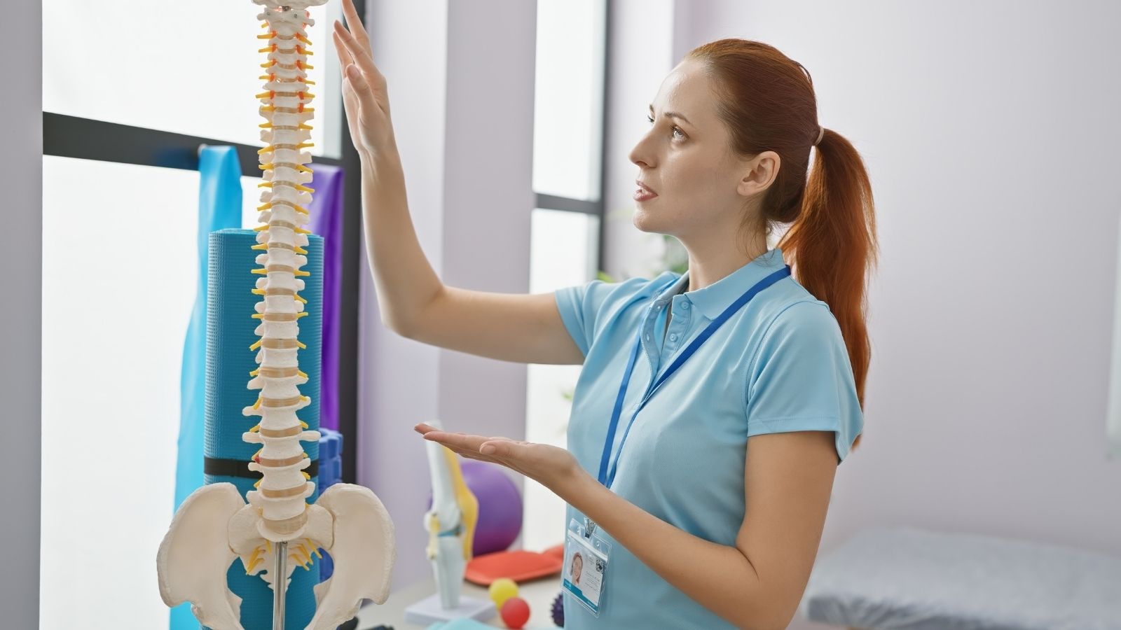 physiotherapist examining a spine in a medical clinic