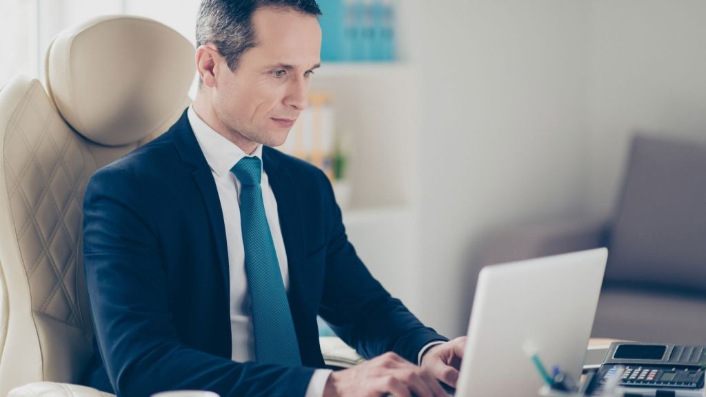 businessman typing on a laptop