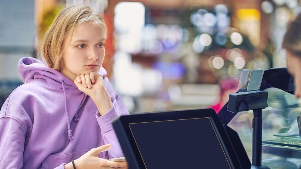 teenage girl waiting for cashier