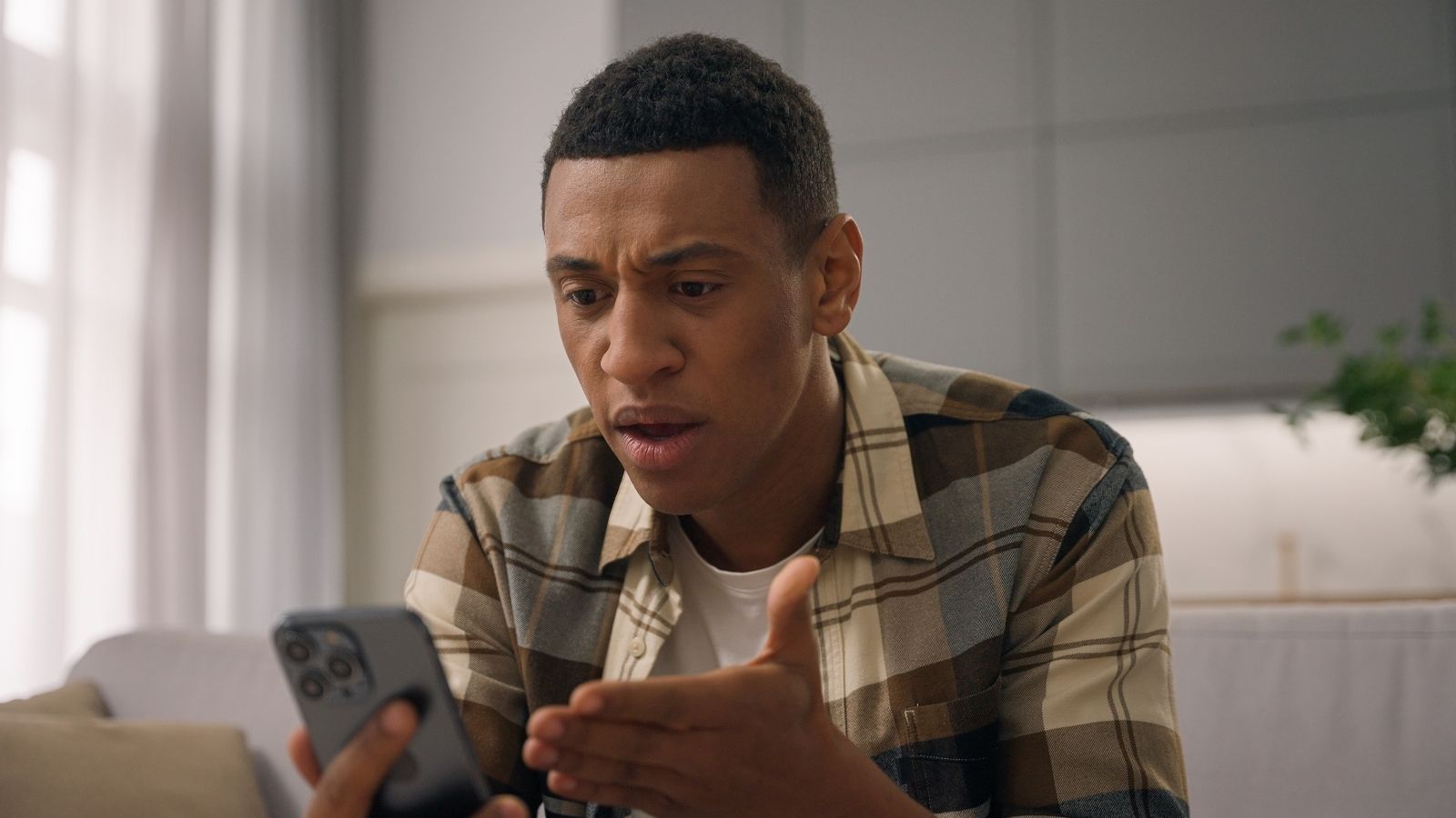 upset man looking at his phone