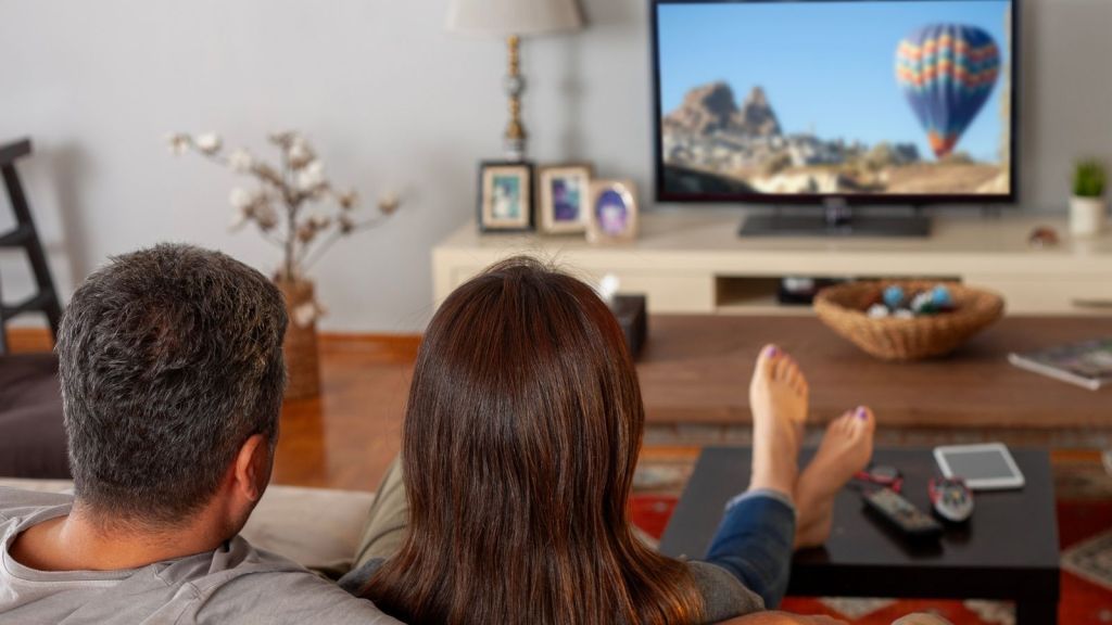 couple watching TV in living room