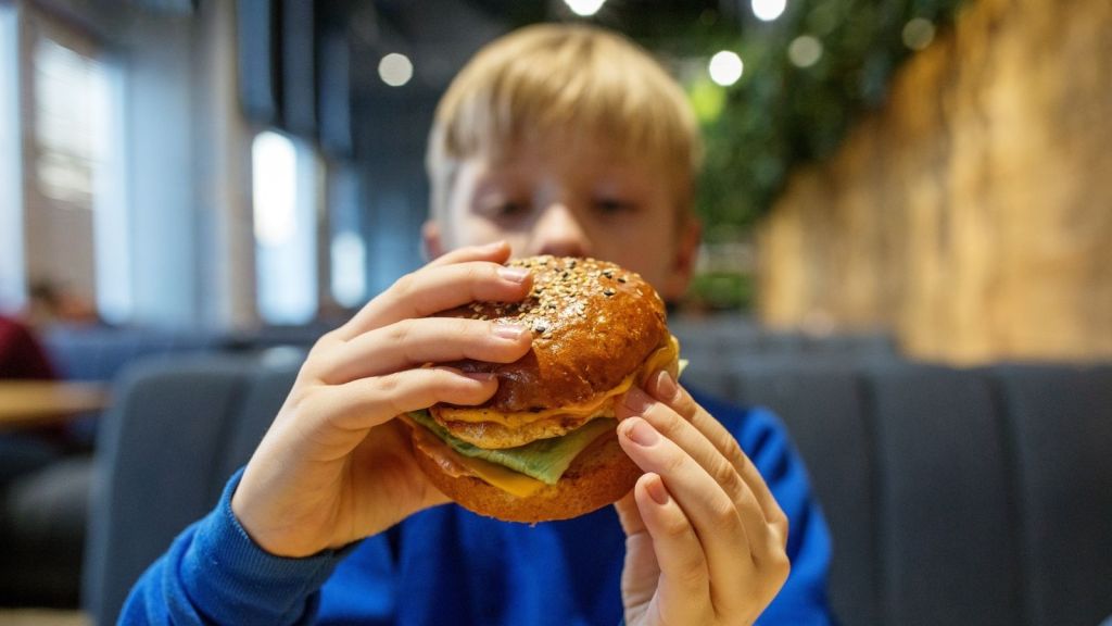 boy holding a burger