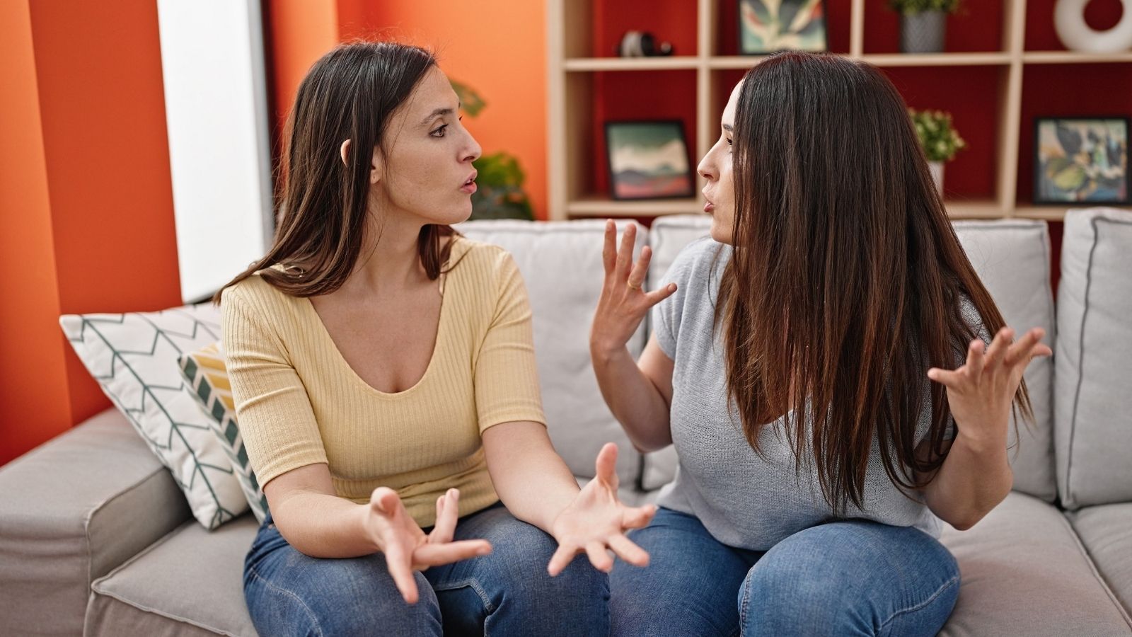 What Started as a Short Term Favor Stretched into Two Months—Now She Wants Her Sister to Help Pay Rent two women sitting on a couch arguing