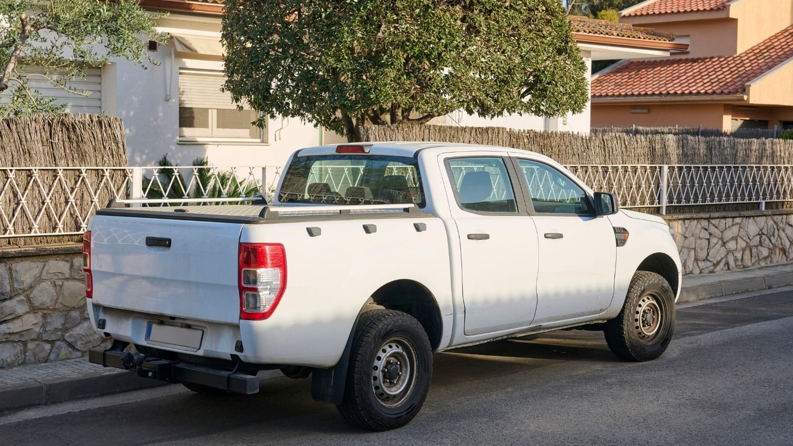 white pickup truck parked on the street