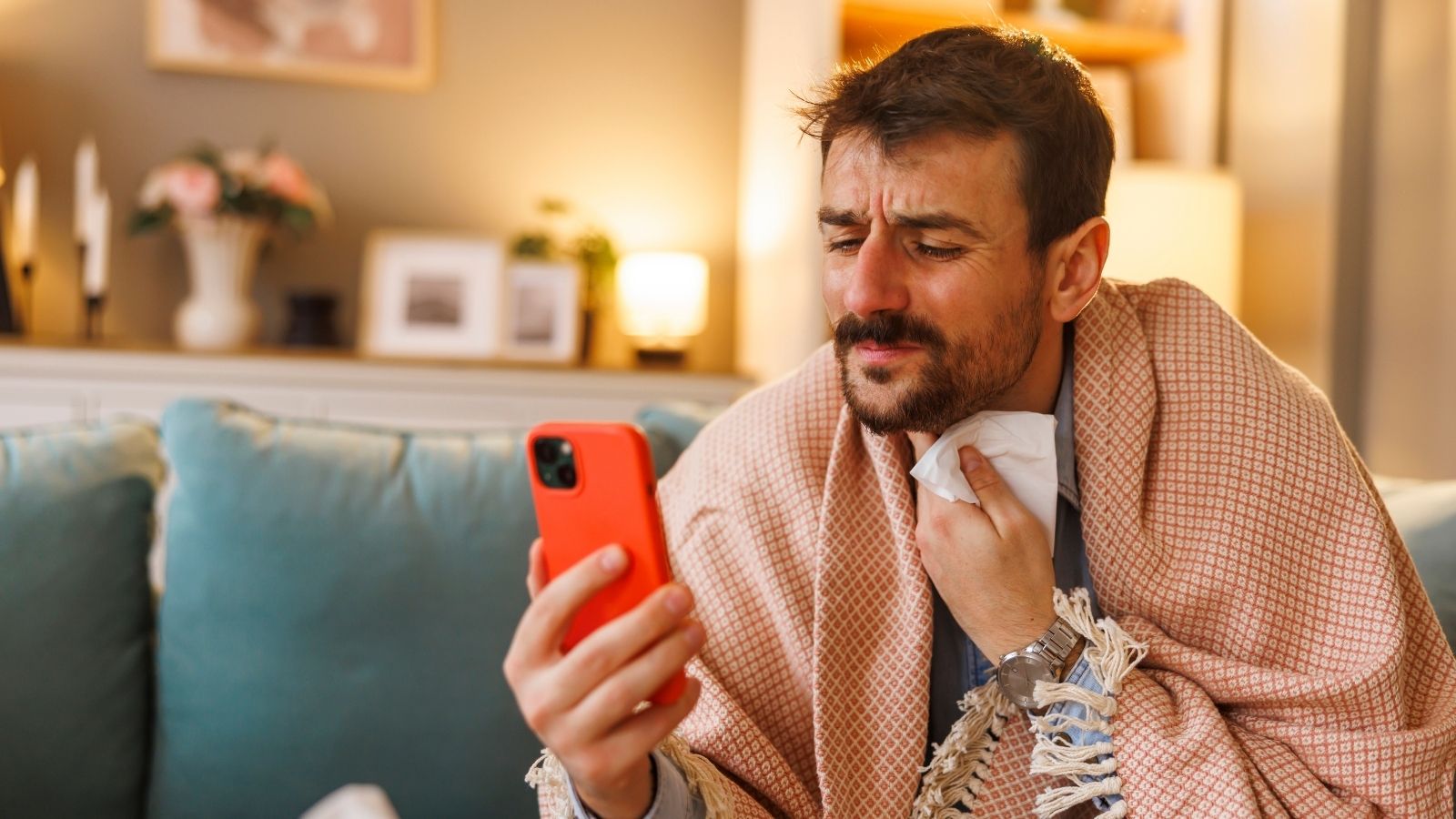 sick man looking at his phone