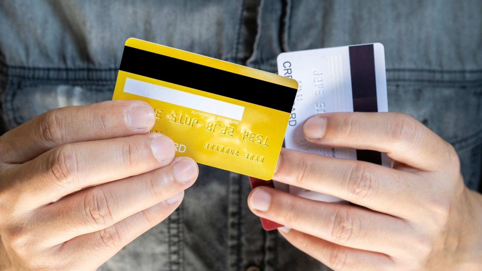 man holding two credit cards