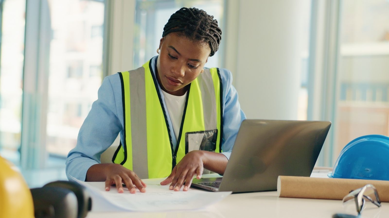 Her Supervisor Wont Promote Her to Engineer — But Has No Problem Handing Her an Engineers Workload woman looking at blueprints on a desk