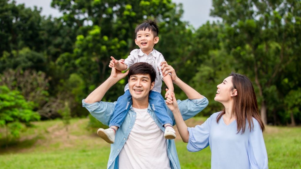 happy parents outside with their son
