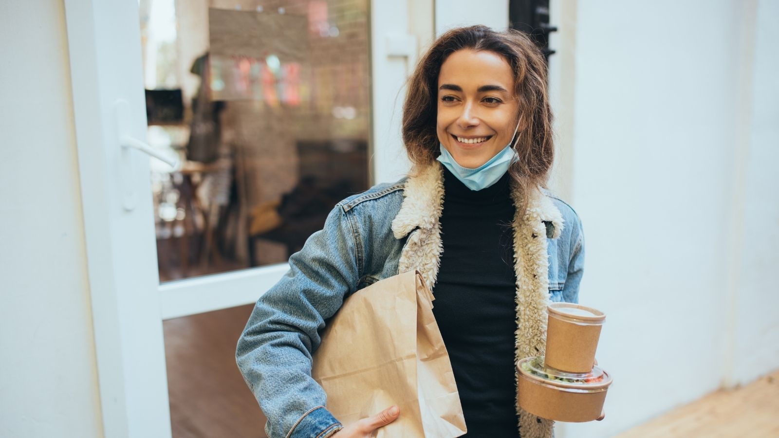 young woman carrying takeout