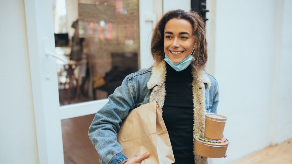 young woman carrying takeout