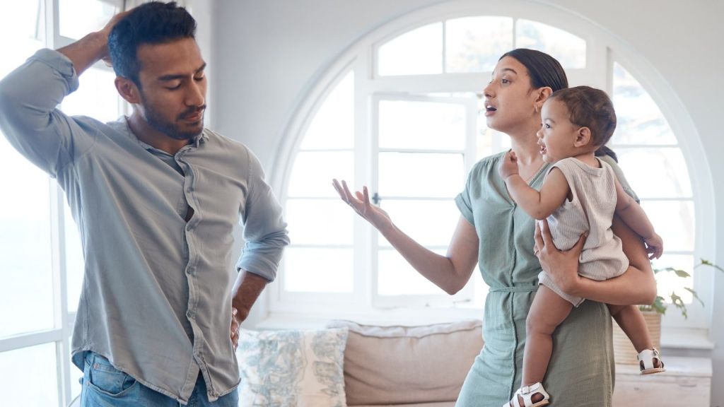 couple arguing while the mom holds a baby