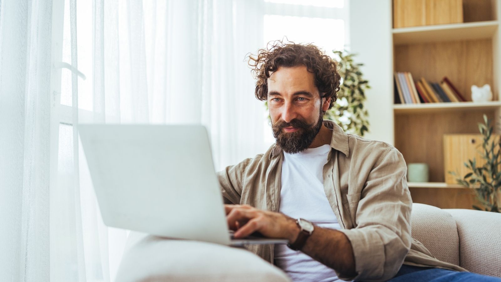 A Man In An HOA Says He Used His Family’s Emergency Fund To Fix His House—But The Story Was Actually A Metaphor For Politics man typing on a laptop