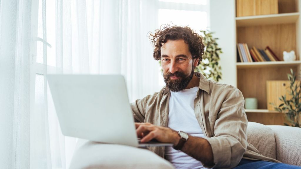 man typing on a laptop