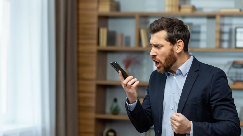 angry businessman talking on the phone