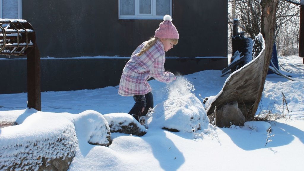 little girl playing in the snow
