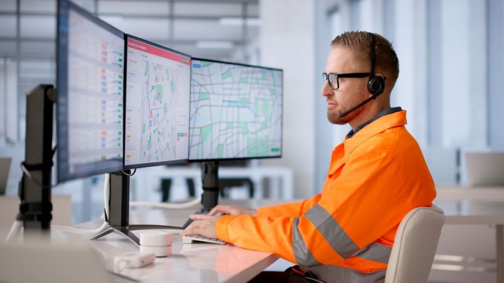 emergency dispatcher looking at monitors