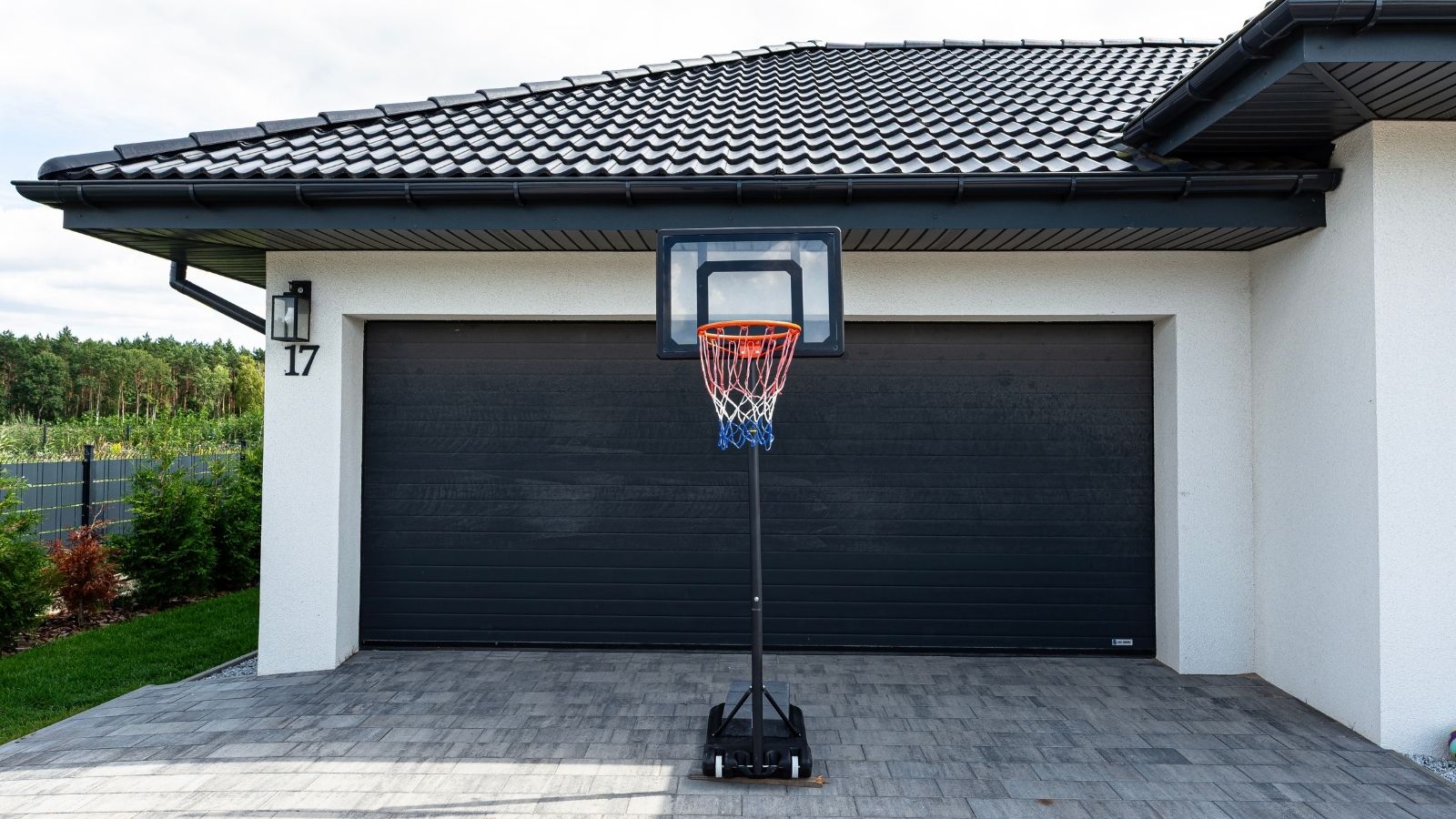 portable basketball hoop in the driveway of a house